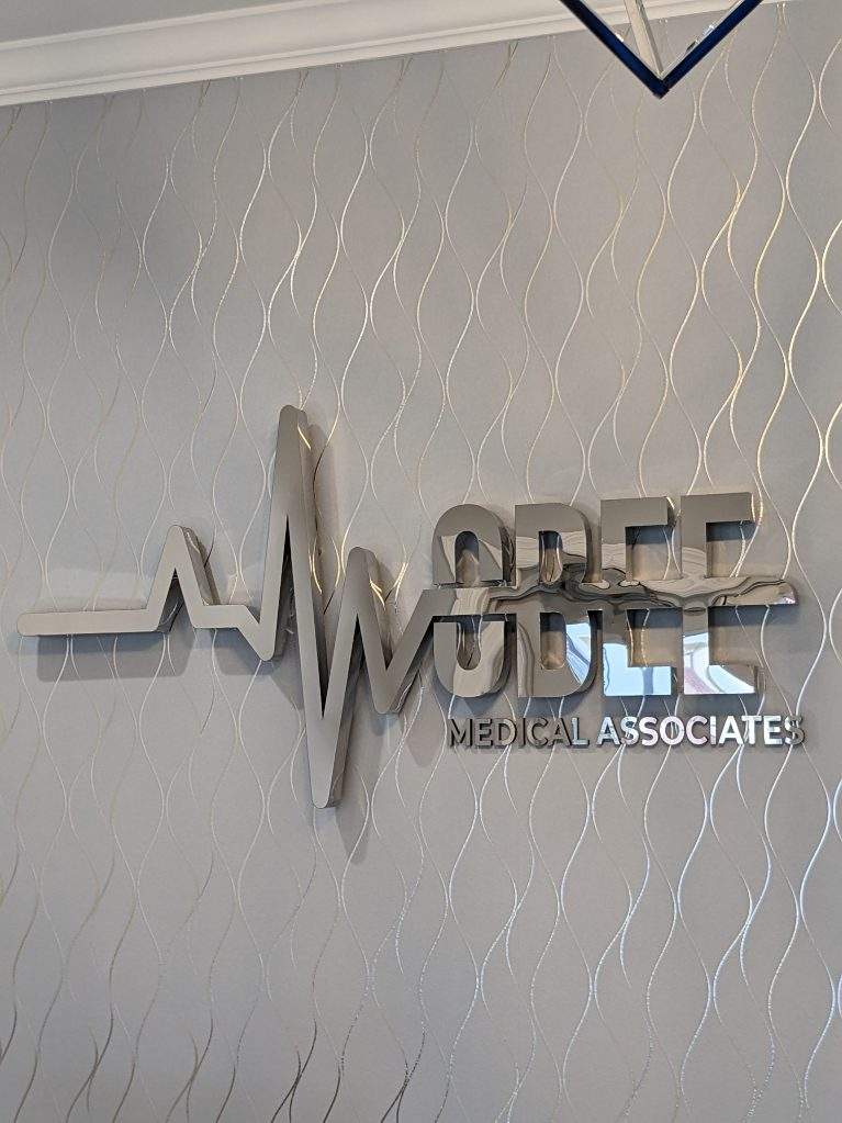 Mobee Medical heartbeat logo detail on office wall